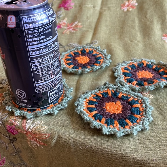 Hand crocheted Mandala coasters in sage green, orange, dark teal and brown. - Picture 5 of 6